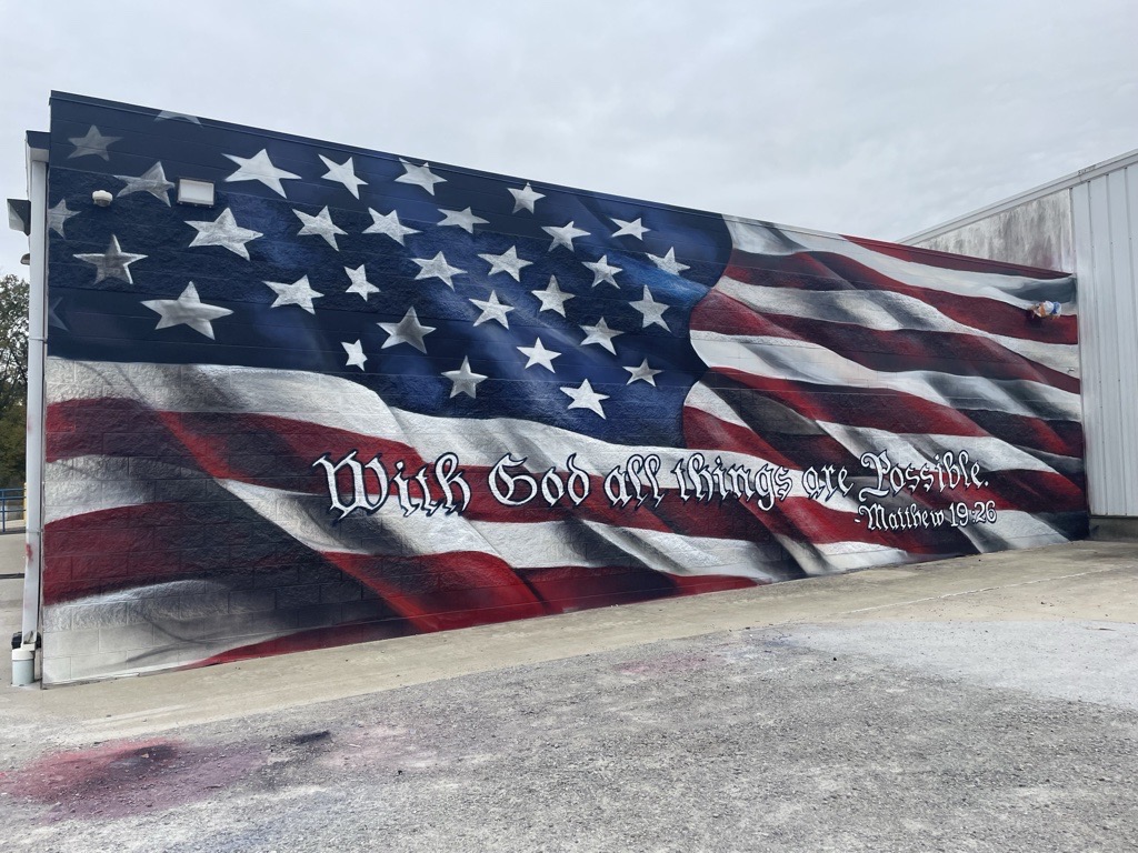 SmartSolve's recently completed mural featuring the American flag waving with Ohio's motto, "With God all things are possible" spelled out.